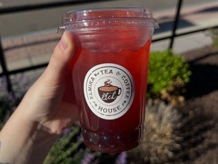 hand holding iced beverage with ETCH logo on the cup