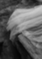 Draped fabric on rocks in a liminal spaces setting.