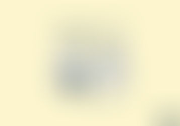 Both characters are seated across from one another at a small, simple table. Not a formal desk—something human. Rounded edges. Almost childlike in scale.