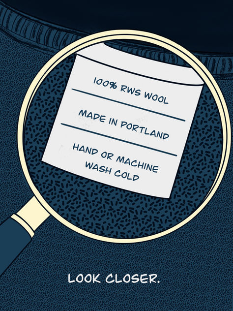 A magnifying glass hovering over a care tag for a t-shirt