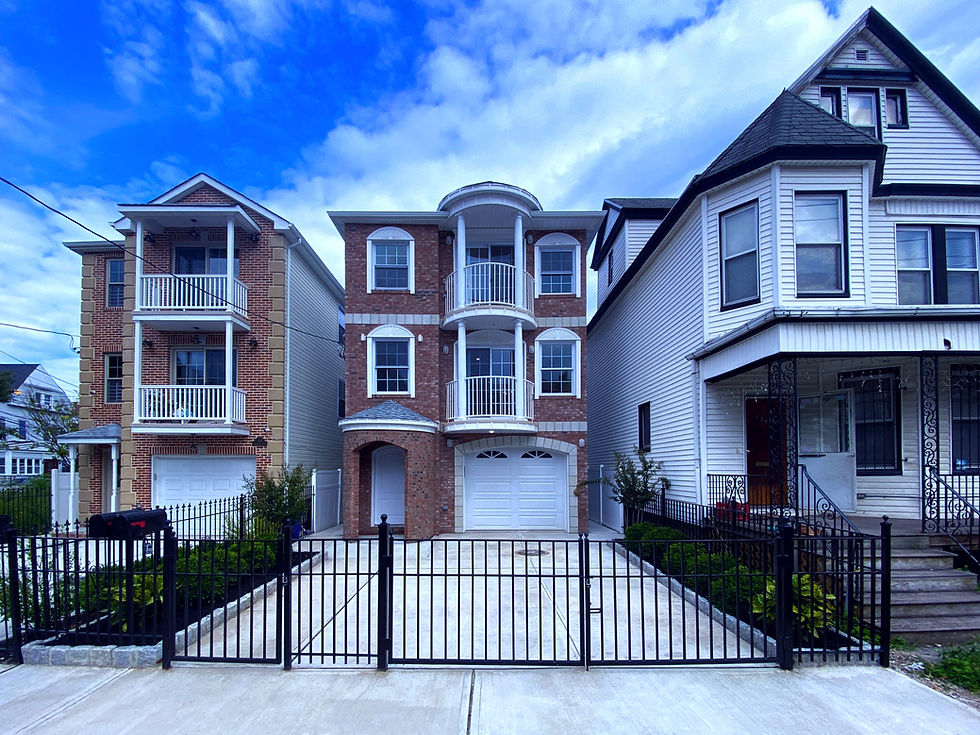 Brand-new brick-front 2-family homes with balconies and garages in Newark, New Jersey