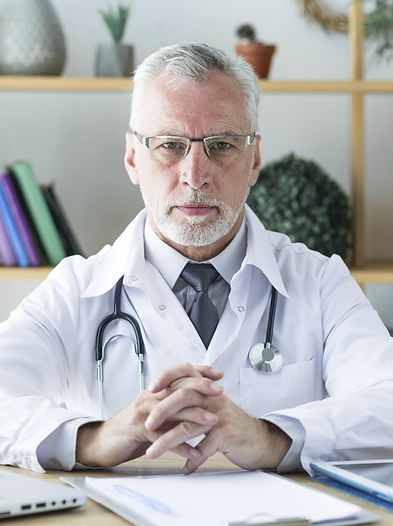 senior-doctor-sitting-office.png