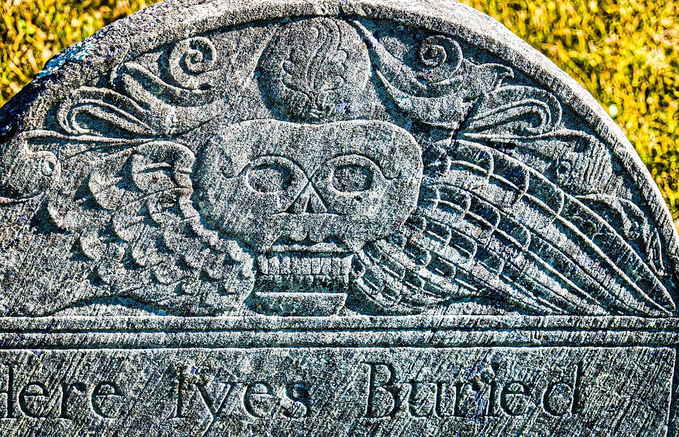 Winged skull carving on an 18th century gravestone symbolizing mortality and the soul.