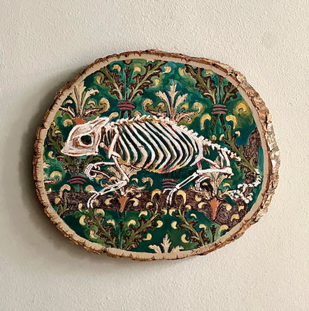 oval shaped basswood plaque with painting of chameleon skeleton over teal Morris print background