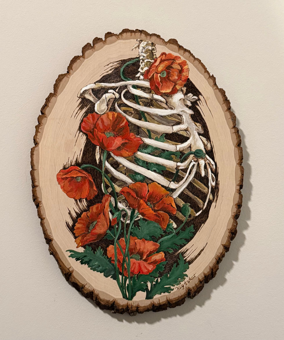 On oval-shaped live-edge wood, pyrography rendering of three quarters view of a human ribcage and spine with painted red poppy flowers growing over it.