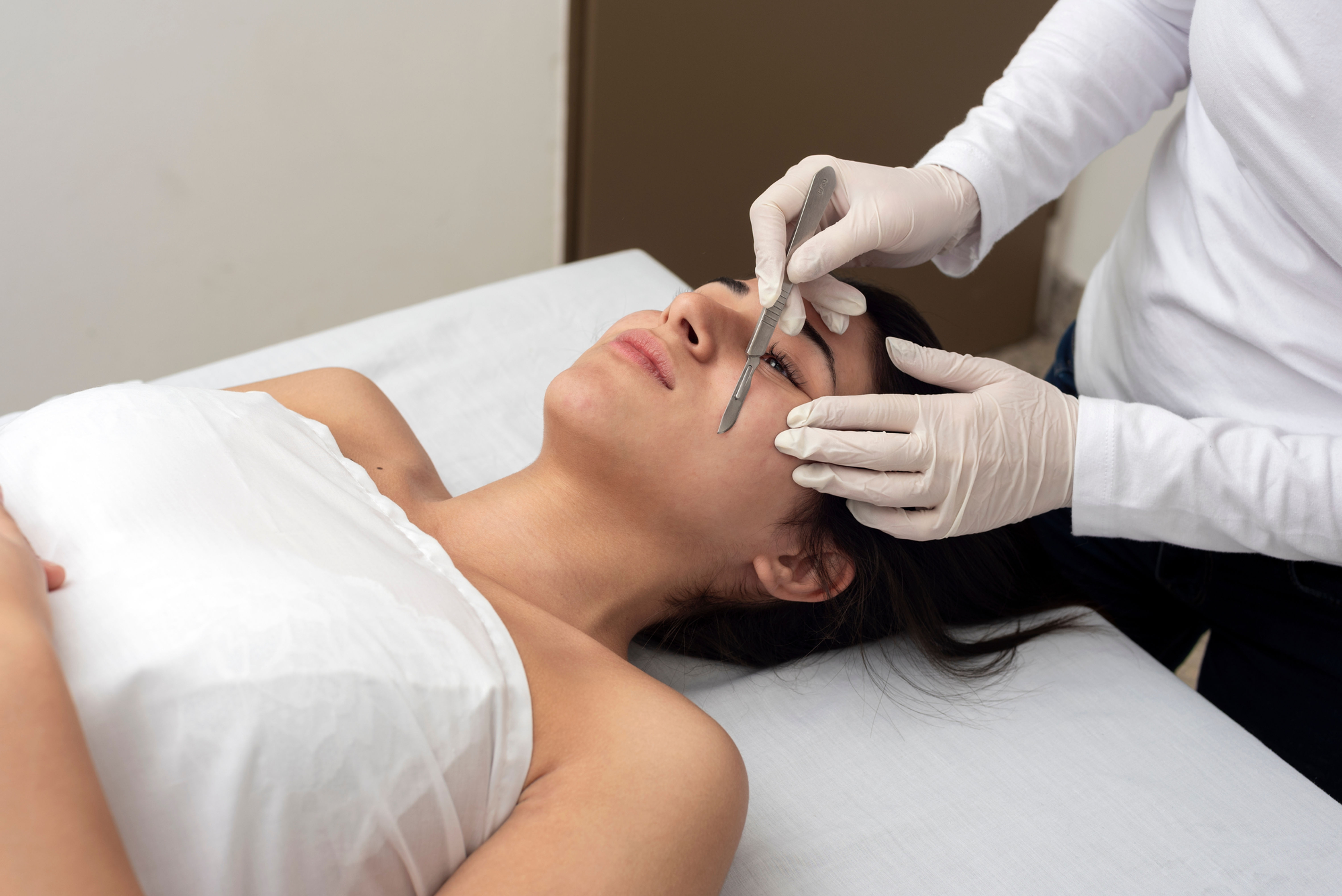 Woman getting dermaplane facial