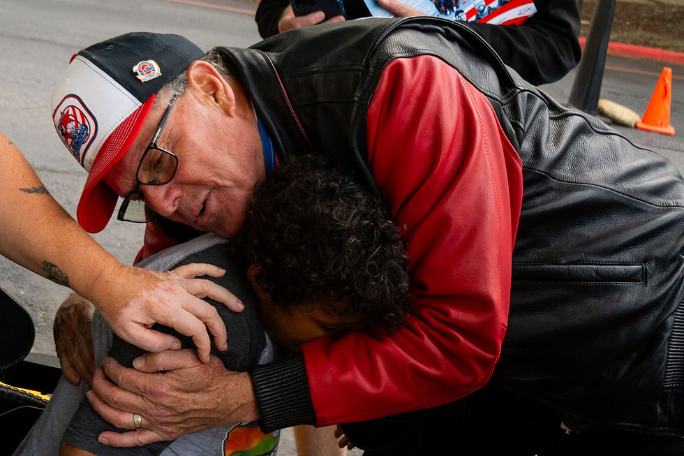 Winston Kelley gives a Victory Junction camper a hug in Asheville, NC.