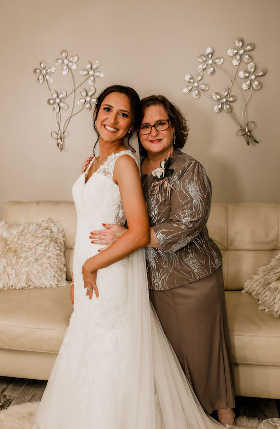 Bride and mother posing together in bridal gown