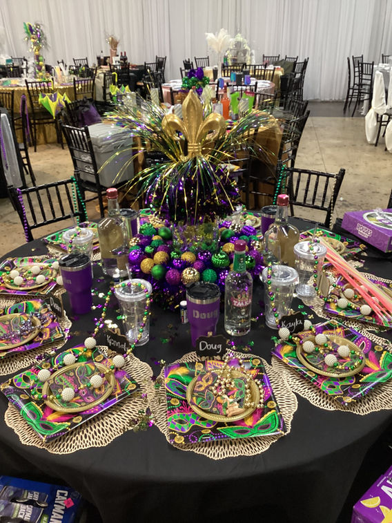 Mardi Gras themed table setting with centerpieces and masks