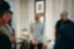 Professional property investor leading discussion on how to get into property, showcasing real estate investment expertise in modern office, demonstrating property investment for beginners