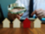 Investor balancing a weighing scale representing financial goals, risk tolerance, and involvement, illustrating property investment tips for 50K in UK and affordable property investments UK
