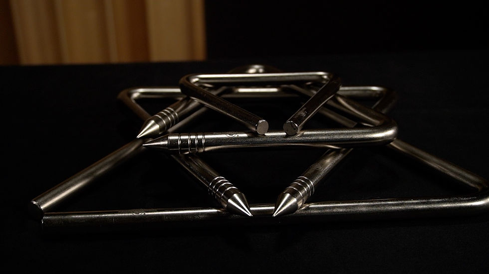 four artisan steel triangles stacked from largest to smallest