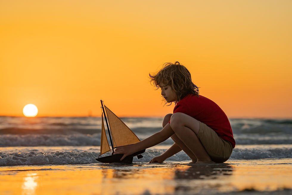 Family childhood concept. Kid boy holding tou boat. Cute little blond boy put toy boat in