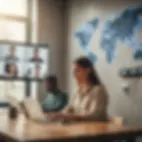 In an office, two people work on laptops with a video call on a screen. A digital world map and clocks are on the wall. Bright daylight.