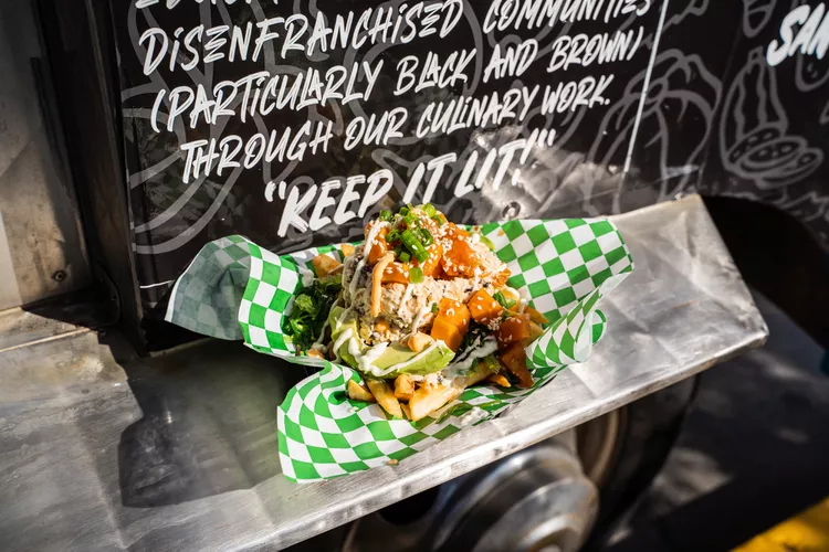 The Vegan Hood Chefs' "Poke Fries": Fresh papaya "poke" marinated in coconut sauce and spices atop crispy potato fries, garnished with fresh seaweed, hearts of palm "crab," wasabi mayo, spicy mayo, and microgreens. Credit: Sabrina Sellers