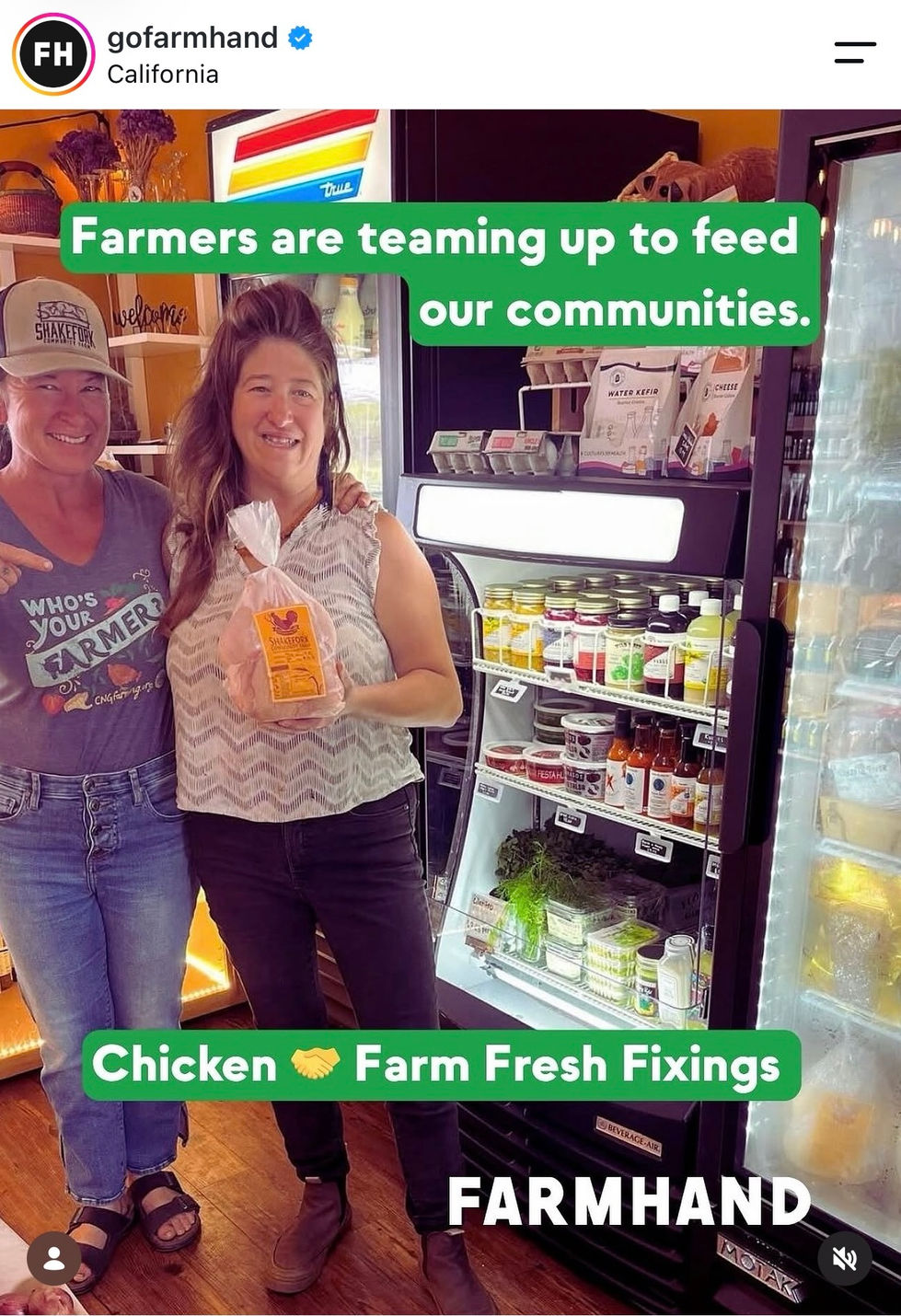 Two people smiling in front of a farm store.