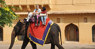 Image of a family riding an elephant to the Amber Palace in Jaipur