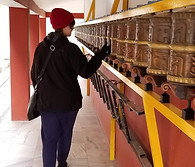 Image of me rolling the prayer wheels outside the Buddhist monastery in Manali