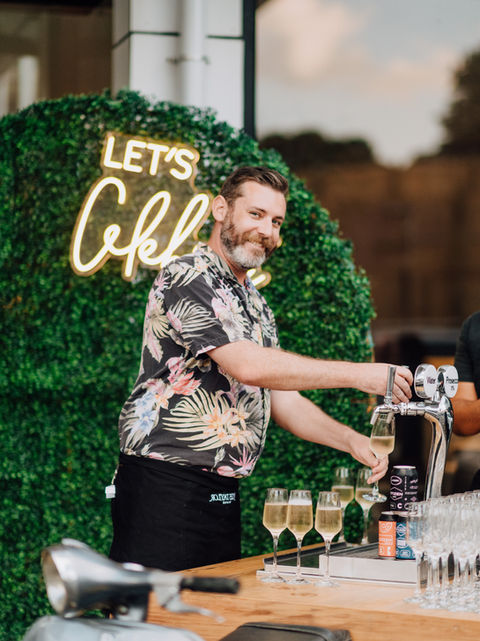 Mobile bar and bartender serving kegged cocktails