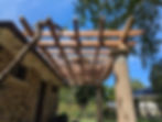 Pergola on stone cottage