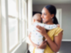 Women smiling holding her baby