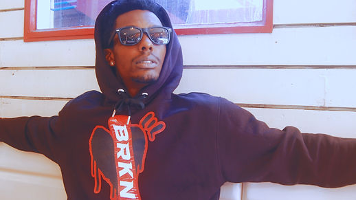 Man wearing BRKN black hoodie with red heart logo – alternative clothing for those built from struggle standing strong