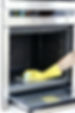 Woman professionally cleaning a dirty oven