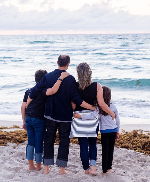 A family unit enjoying a day at the beach.