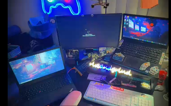 My desk with 3 of my many computers/laptops set up to work on