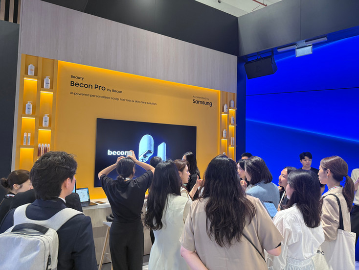 The becon booth surrounded by a crowd