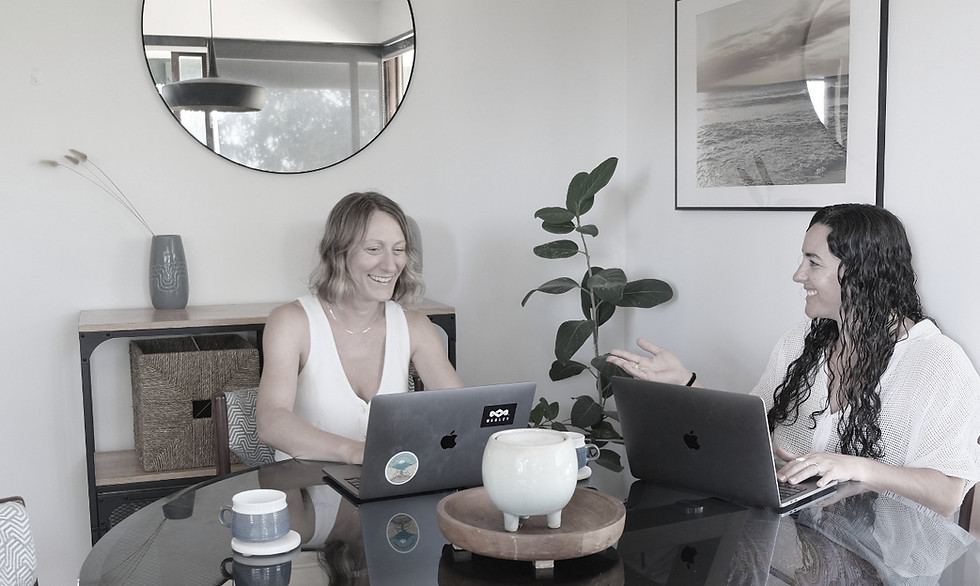 Two women working on laptops at a round table, Startup Digital, websites for small business.
