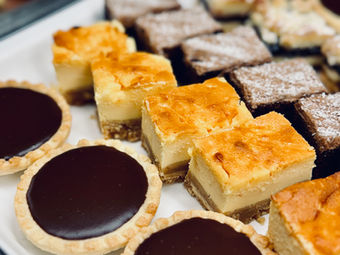 Dessert platter with mini chocolate tarts and cheesecake squares