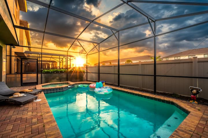 Private pool at sunset under the screen enclosure