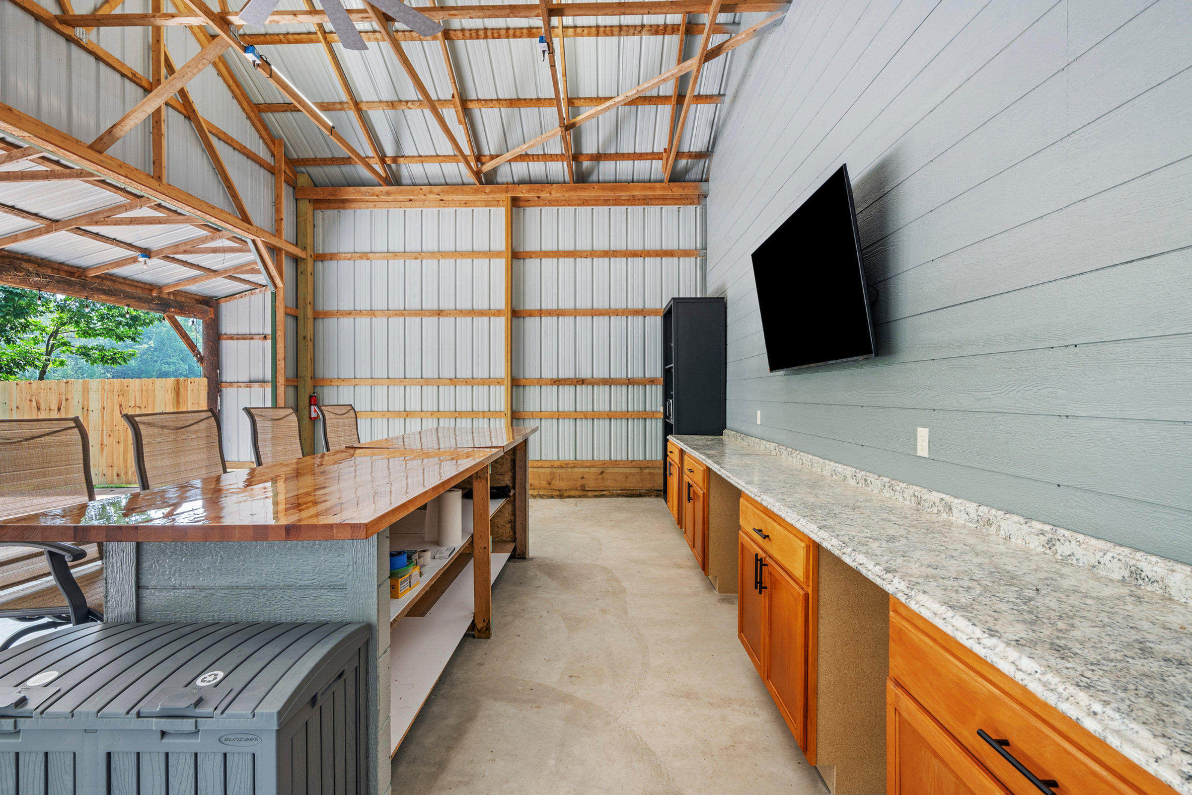 Live-edge wood bar and wall-mounted TV inside the converted barn