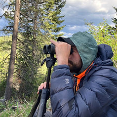 An outdoorsman using binoculoars
