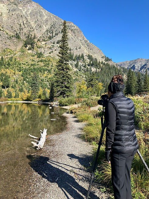 photographer with tripod at glacier national park in two medicine