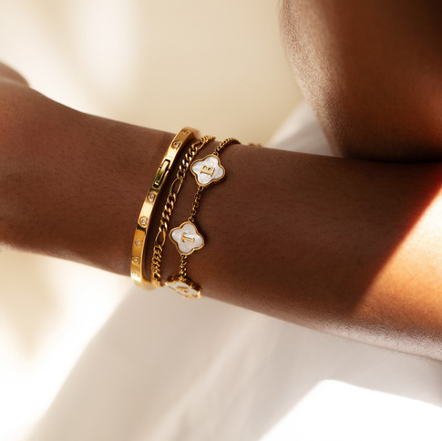 E-commerce Jewellery Photoshoot UK - Gold Bracelet on Model: On-model jewellery photography featuring a gold bracelet worn elegantly on the wrist. Captured in a bright, minimalist setting to emphasise the luxury and sophistication of the piece. Tailored for UK jewellery brands seeking top-tier product photography services for their online stores and marketing campaigns.