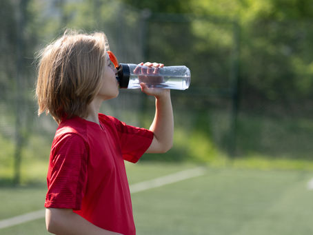 Young Athlete Drinking Water