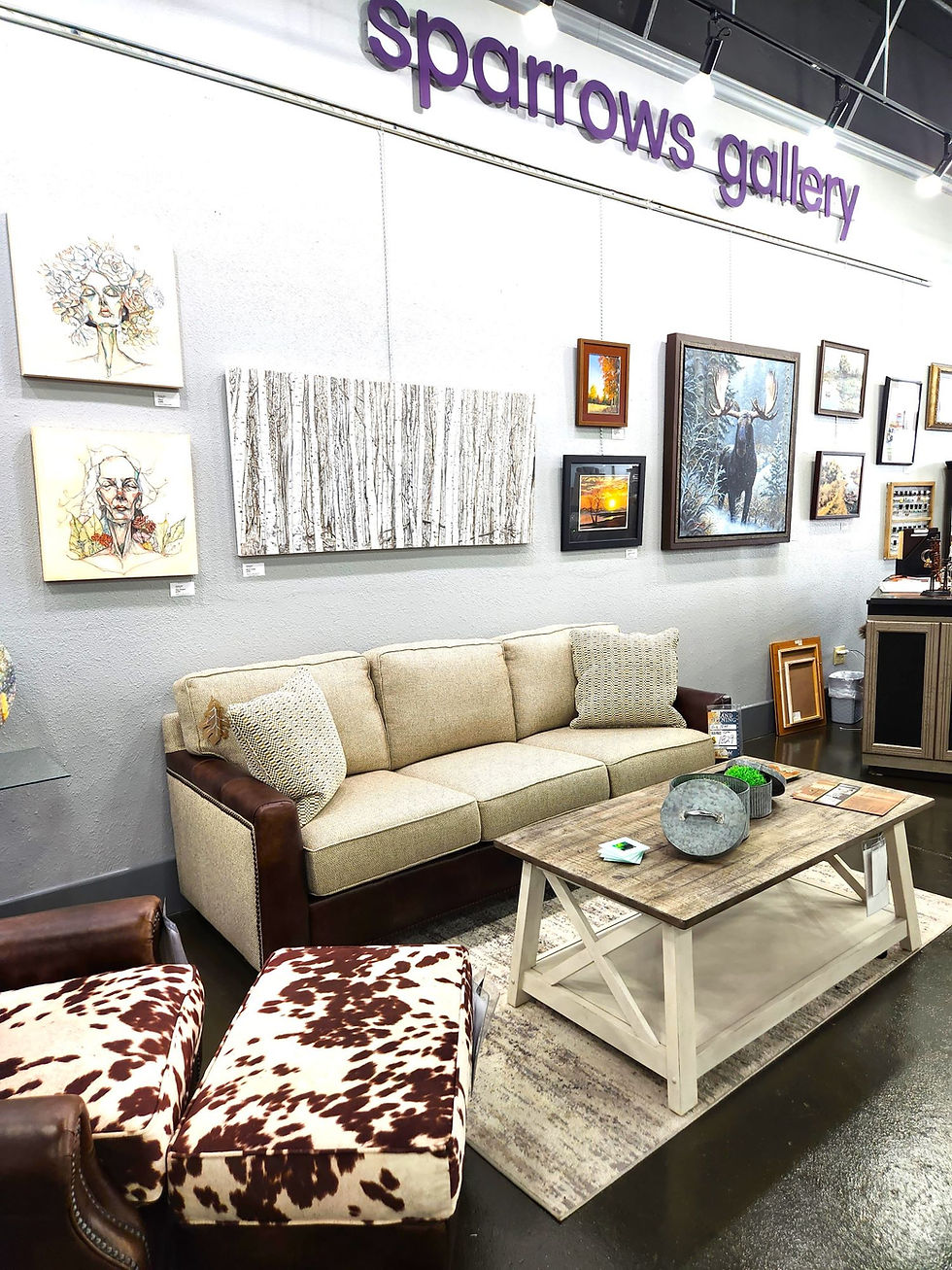 Eye-level view of a modern gallery wall with diverse paintings and sculptures