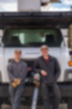 Patrick Heatherman and Connor Jettner, co-owners of Desert Pine Arbor Care, standing together in Central Oregon with tree care equipment in the background. ISA-certified arborists and local tree experts specializing in pruning, removals, and wildfire mitigation.