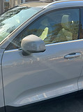 Partial driver-side view of a gray Volvo with side mirror, featured in Tolon Detail Services exterior detailing and ceramic coating showcase.