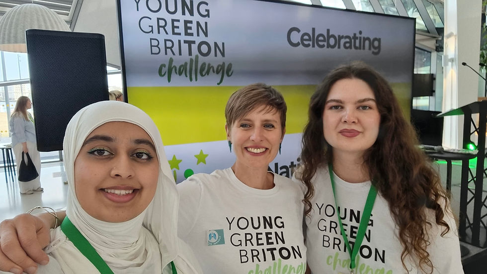Three women looking at the camera, one in a white hijab, one with short light brown hair and one with long dark brown hair