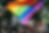 Rainbow pride flag waving in the wind at a pride parade