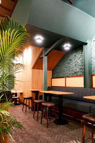 Existing shophouse architecture thoughtfully preserved and integrated into the interior