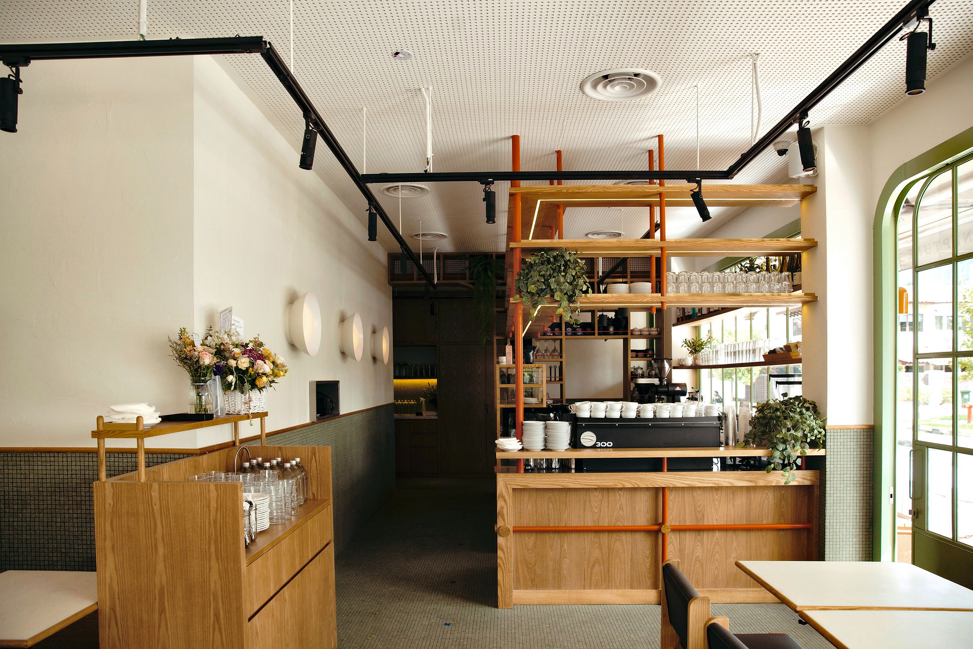 Contemporary café interior balancing clean lines with organic textures