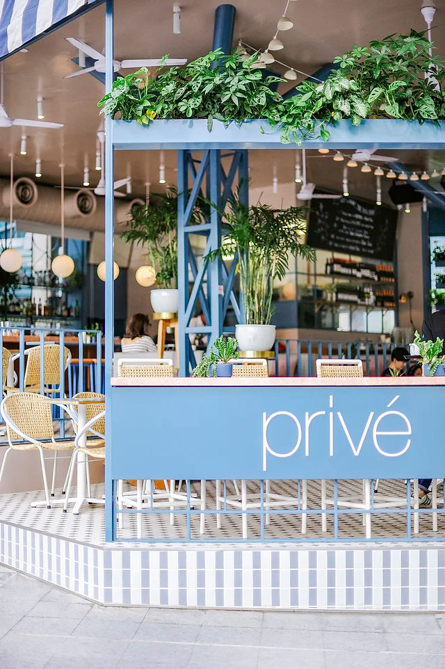 Entrance welcoming guests into a contemporary cafe and restaurant at Wheelock Place