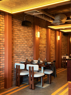 Furniture composition within contemporary Indian restaurant environment