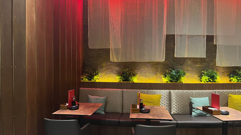 Layered seating arrangement within contemporary Japanese dining environment