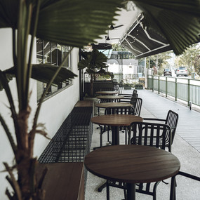 Layered cafe environment shaped through openness and natural elements