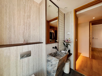 Stone surfaces, timber textures and brass accent within residential interior